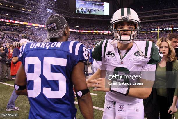 Quarterback Mark Sanchez of the New York Jets walks by Pierre Garcon of the Indianapolis Colts after the Jets lost to the Colts 30-17 in the AFC...