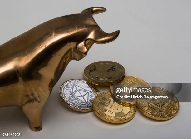 Symbol photo on the topics cryptocurrency, Ethereum, currency speculation, power consumption, etc. The picture shows a bull with Ethereum, Ripple,...
