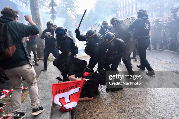 Riot police baton a demonstrator on May 22, 2018 in Paris, during a nationwide day protest by French public sector employees and public servants...