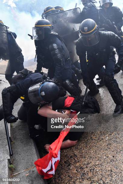 Riot police baton a demonstrator on May 22, 2018 in Paris, during a nationwide day protest by French public sector employees and public servants...