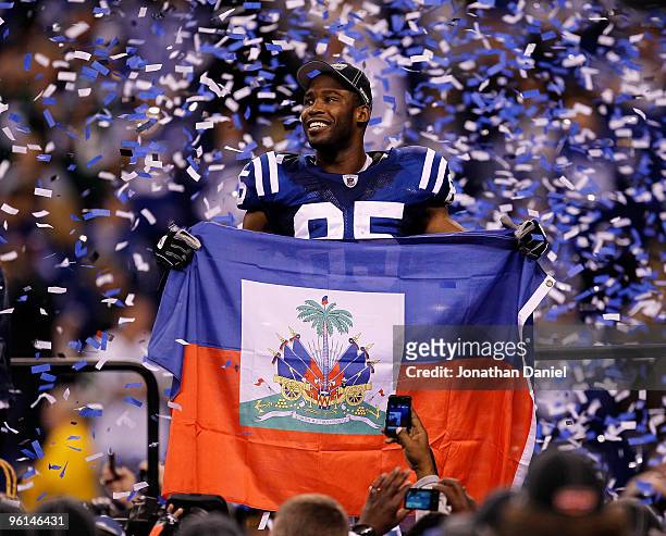 Pierre Garcon of the Indianapolis Colts holds up a Haitian flag during the Lamar Hunt Trophy presentation after defeating the New York Jets 30-17...
