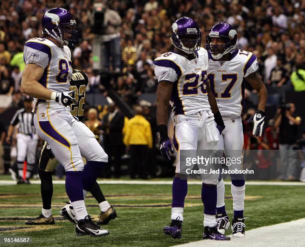 Adrian Peterson of the Minnesota Vikings celebrates after scoring a touchdown in the first quarter with teammates Jeff Dugan and Greg Lewis against...