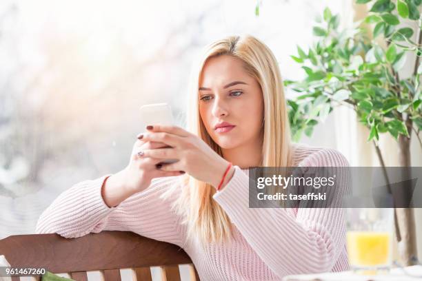 woman using her mobile phone - taseffski stock pictures, royalty-free photos & images