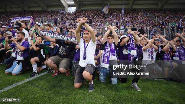 Fans of Aue celebrate after their team won the 2. Bundesliga Playoff Leg 2 match between Erzgebirge Aue and Karlsruher SC at...