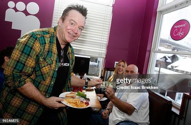 Actor Tom Arnold waits on baseball player David Wells table at the MySpace Cafe at The Lift on January 24, 2010 in Park City, Utah.