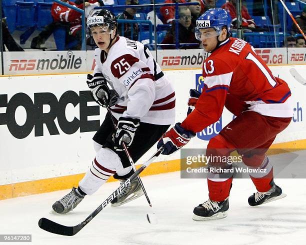 Martins Jakovlevs of Team Latvia and Robert Kousal of Team Czech Republic chase the puck into the corner during the 2010 IIHF World Junior...
