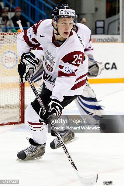 Janis Kalnins of Team Latvia skates with the puck during the 2010 IIHF World Junior Championship Tournament Relegation game against Team Czech...