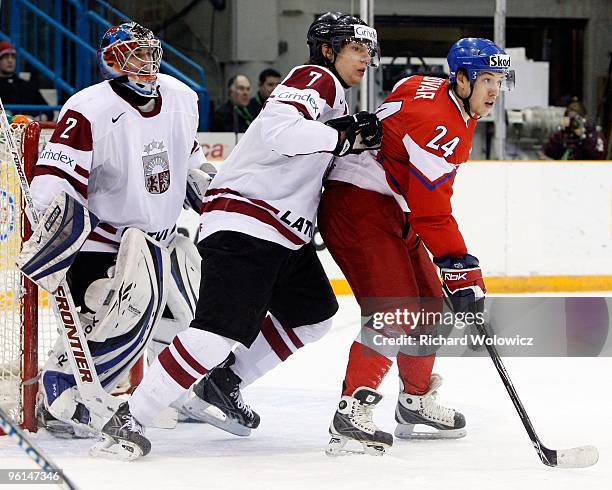 Raimonds Vilkoits of Team Latvia defends against Jan Kovar of Team Czech Republic during the 2010 IIHF World Junior Championship Tournament...