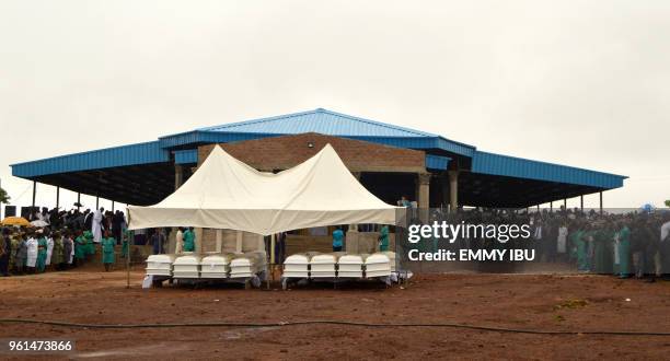 Coffins of 17 worshippers and two priests, who were allegedly killed by Fulani herdsmen stand during a funeral service at Ayati-Ikpayongo in Gwer...