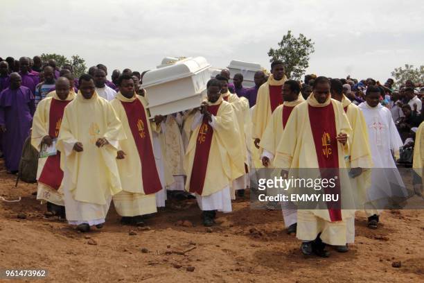 Clergymen carry white coffins containing the bodies of priests allegedly killed by Fulani herdsmen, for burial at Ayati-Ikpayongo in Gwer East...