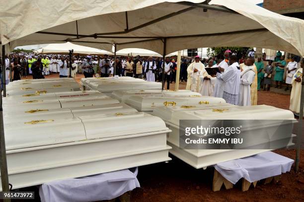 Coffins of 17 worshippers and two priests, who were allegedly killed by Fulani herdsmen stand during a funeral service at Ayati-Ikpayongo in Gwer...