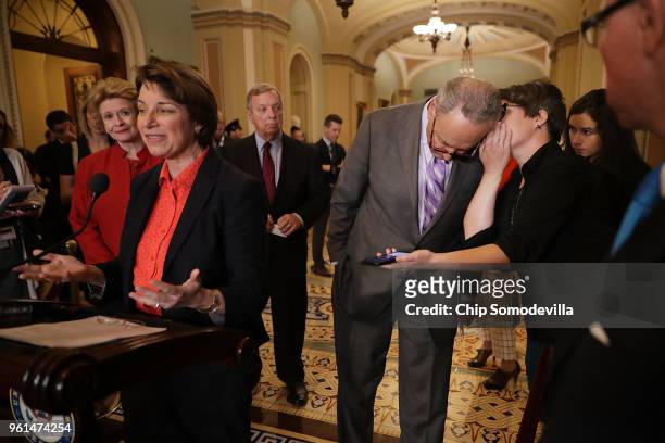 Sen. Amy Klobuchar talks to reporters as Senate Minority Leader Charles Schumer hears from HuffPost reporter Jennifer Bendrey following the weekly...