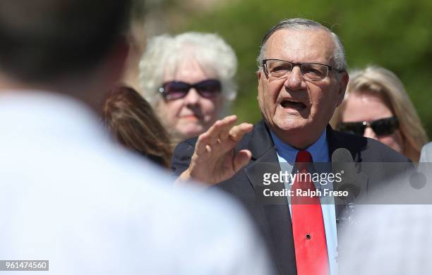 Former Maricopa County Sheriff Joe Arpaio answers questions from the media in front of the Arizona State Capitol before filing petitions to run for...