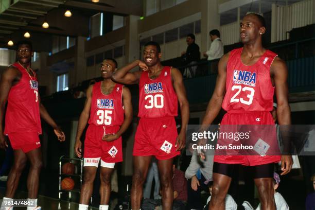 Patrick Ewing of the East team, Hersey Hawkins of the East team, Bernard King of the East team, and Michael Jordan of the East team practice during...