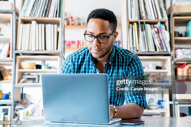 businessman working on laptop computer in office - gingham stock pictures, royalty-free photos & images