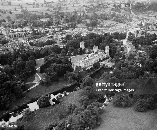 Warwick Castle, Warwickshire, 1920. Aerial view of the castle with the River Avon in the foreground, with the church and town beyond. Artist...