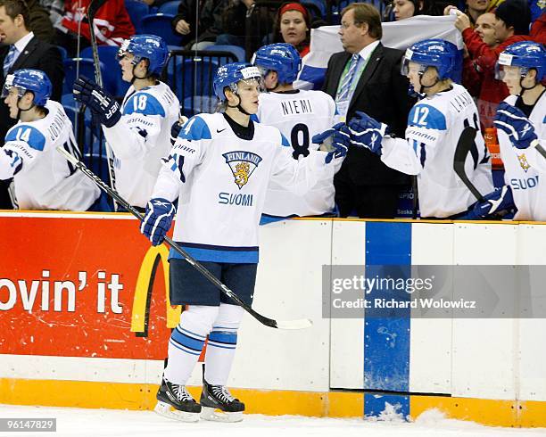 Teemu Eronen of Team Finland celebrates a goal with team mates during the 2010 IIHF World Junior Championship Tournament Fifth Place game against...