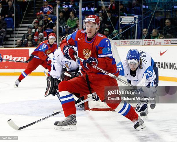 Magomed Gimatov of Team Russia skates while being defended by Veli-Matti Vittasmaki of Team Finland during the 2010 IIHF World Junior Championship...