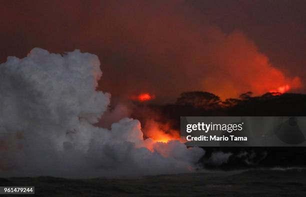 Steam plume rises as lava enters the Pacific Ocean at dawn, after flowing to the water from a Kilauea volcano fissure, on Hawaii's Big Island on May...