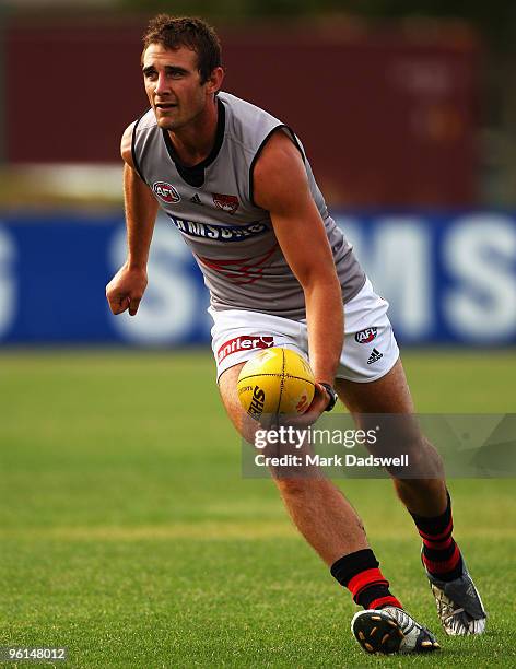 Jobe Watson captain of the Bombers handballs to a teammate during an Essendon Bombers AFL training session at Windy Hill on January 25, 2010 in...