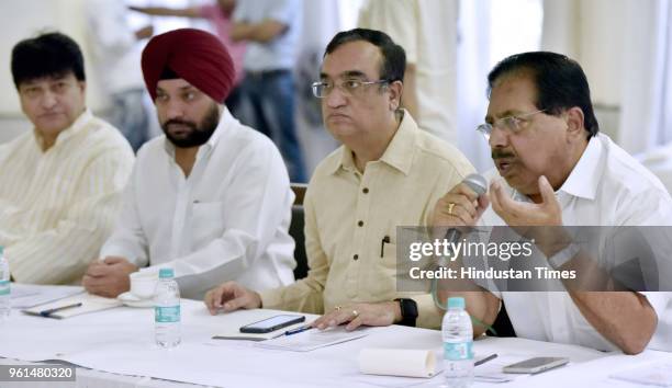 Delhi AICC in-charge P. C. Chacko speaks as DPCC President Ajay Maken , party leader Arvinder Singh Lovely and others look on during a monthly...