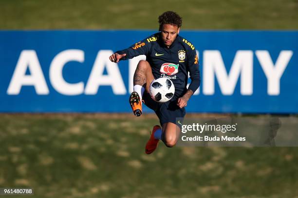 Neymar controls the ball during a training session of the Brazilian national football team at the squad's Granja Comary training complex on May 22,...