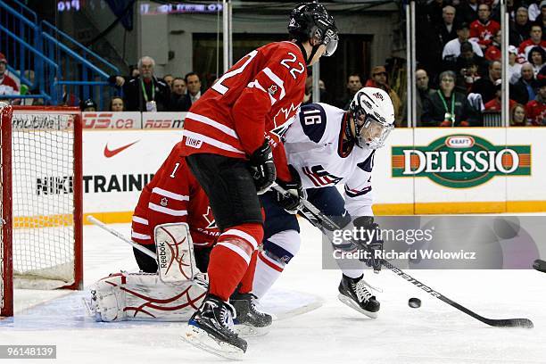 Jason Zucker of Team USA watches the loose puck in front of Jake Allen and Jared Cowen of Team Canada during the 2010 IIHF World Junior Championship...