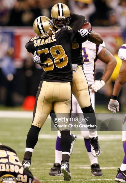Jonathan Vilma and Scott Shanle of the New Orleans Saints celebrate a defensive stop in the second quarter against the Minnesota Vikings during the...
