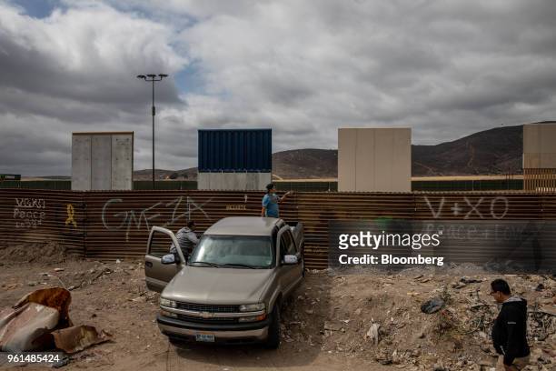 People view prototypes for the new U.S. -Mexico border wall in Tijuana, Mexico, on Monday, May 21, 2018. "We won't care about threats of a wall,"...