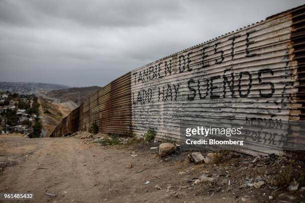 Graffiti on a section of a U.S.-Mexico border wall reads "On this side there are dreams too" in Tijuana, Mexico, on Monday, May 21, 2018. "We won't...