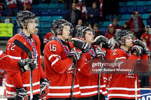 Members of Team Canada stand dejected after being defeated by Team USA at the 2010 IIHF World Junior Championship Tournament Gold Medal game on...