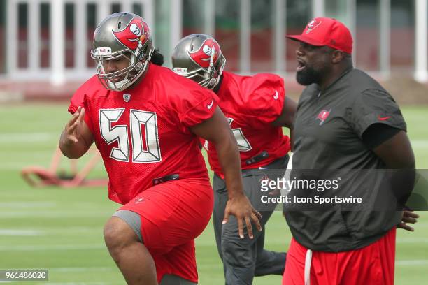 First round pick Vita Vea goes thru drills under the close eye of defensive line coach Brentson Buckner during the Tampa Bay Buccaneers OTA on May...