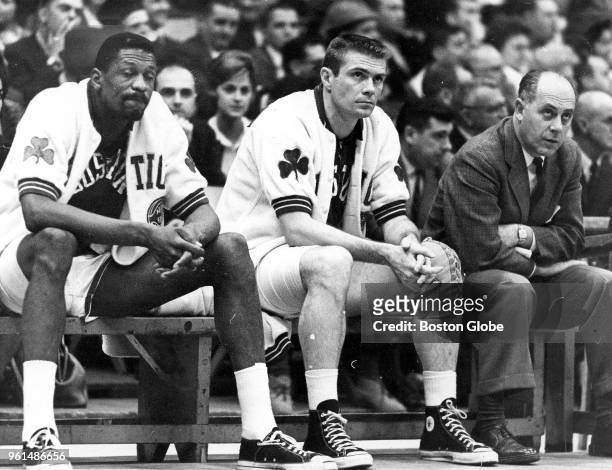 From left, Boston Celtics Bill Russell, Tom Heinsohn and Red Auerbach sit on the bench during a playoff game against the Cincinnati Royals at the...