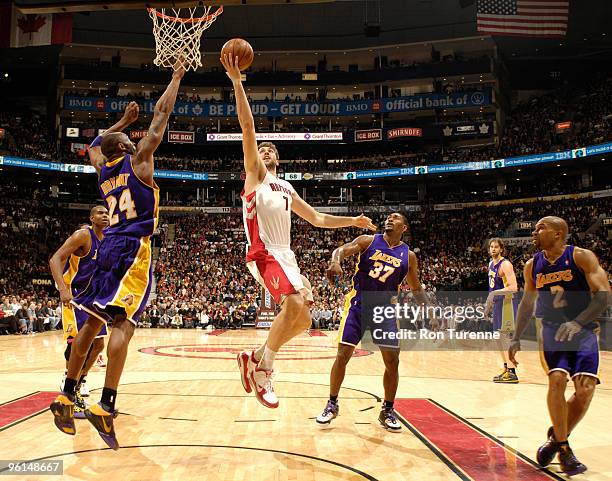 Andrea Bargnani of the Toronto Raptors drives the lane and tries the finger-roll over a jumping Kobe Bryant of the Los Angeles Lakers during a game...