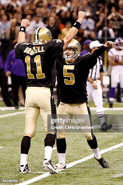 Kicker Garrett Hartley and holder Mark Brunell of the New Orleans Saints celebrate after Hartley kicked a 40-yard game-winning field goal in overtime...