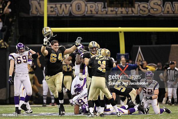 Kicker Garrett Hartley of the New Orleans Saints celebrates with teammates David Thomas, Zach Strief and Mark Brunell after kicking a 40-yard...