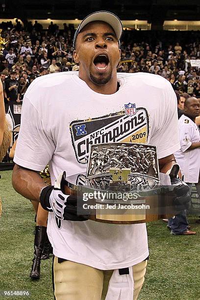 Darren Sharper of the New Orleans Saints celebrates with the NFC Championship trophy after defeating the Minnesota Vikings to win the NFC...