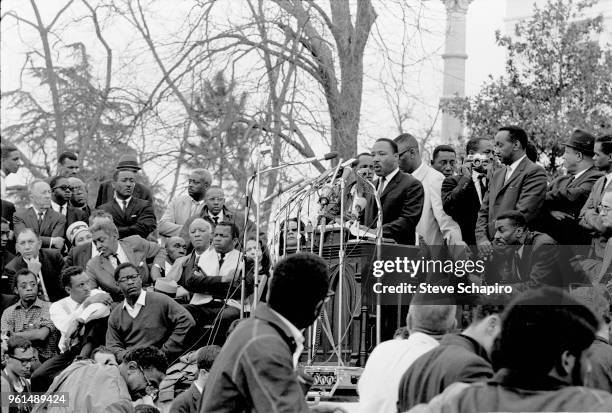 American religious and Civil Rights leader Dr Martin Luther King Jr speaks from a pulpit in front of the Montgomery State Capitol building at the...