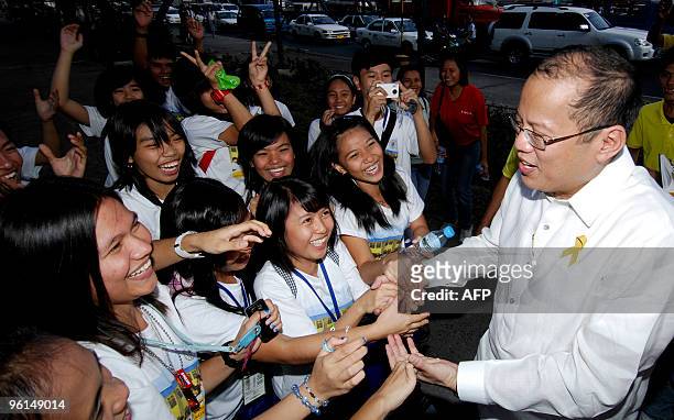 Philippine presidential candidate and Senator Benigno 'Noynoy' Aquino , son of Democracy icon and former president Corazon Aquino, shakes hands with...