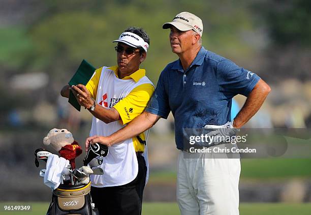 Tom Lehman gets yardage from his caddie on during the final round of the Mitsubishi Electric Championship at Hualalai held at Hualalai Golf Club on...