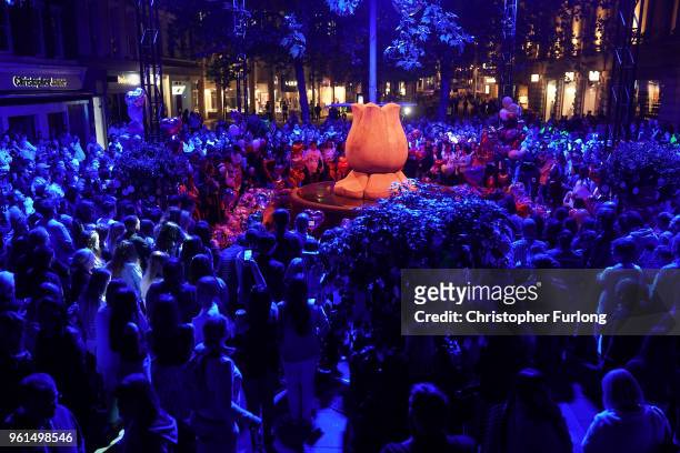 People are illuminated by blue light as they stand in silence in St Ann's Square at 2231, the exact time the Manchester attacker detonated his bomb...