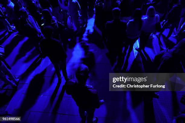 People are illuminated by blue light as they stand in silence in St Ann's Square at 2231, the exact time the Manchester attacker detonated his bomb...