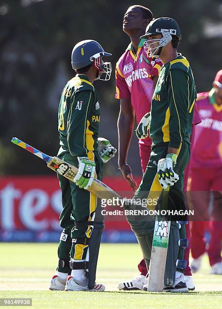 Pakistani Sarmad Bhatti talks to Hammad azam in the closing stages of the game as west Indie bowler Jason Holder reacts during the semi-finals of the...