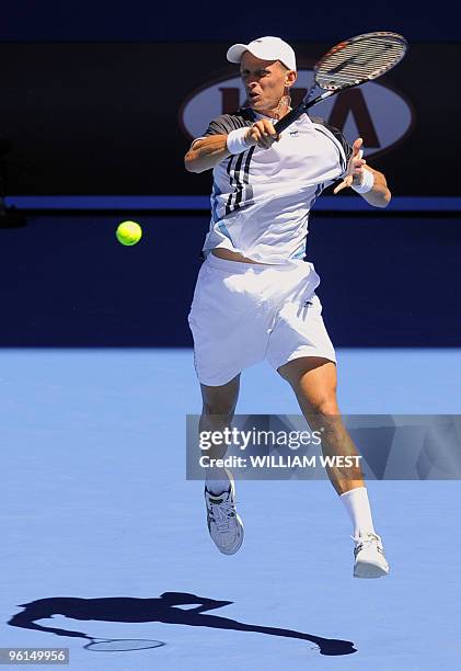 Nikolay Davydenko of Russia hits a return against Fernando Verdasco of Spain in their men's singles fourth round match on day eight of the Australian...