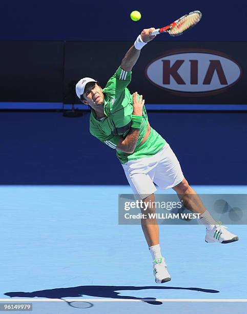 Fernando Verdasco of Spain serves against Nikolay Davydenko of Russia in their men's singles fourth round match on day eight of the Australian Open...