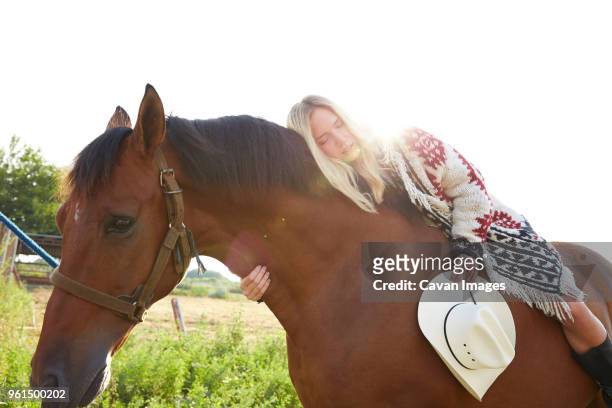 low angle view of woman sleeping on horse in farm - low rider bildbanksfoton och bilder