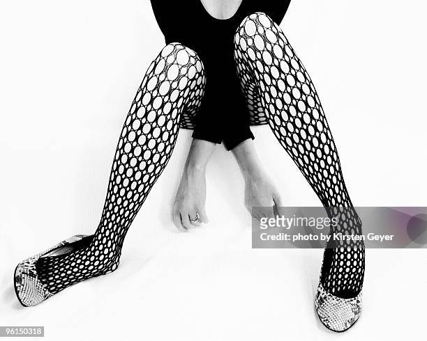 young woman's legs posing in black stockings - women wearing black stockings stock pictures, royalty-free photos & images