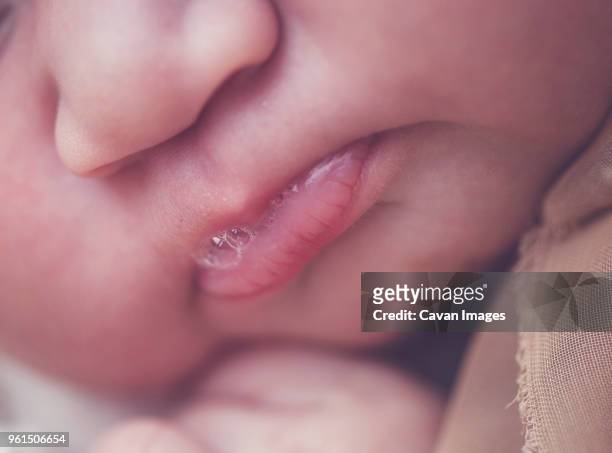 extreme close-up of newborn baby girl's lips - baby spit up stock-fotos und bilder