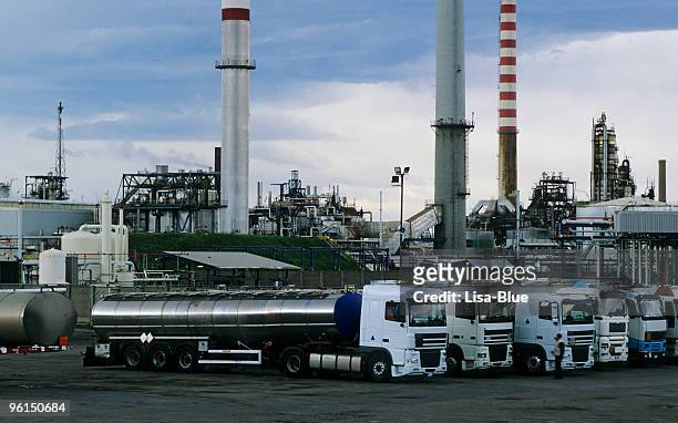 trucks and chemical plant - truck smog stock pictures, royalty-free photos & images