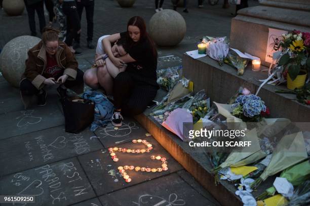 People pay their respects during a ceremony in central Manchester, May 22 marking the one year anniversary of the deadly attack at Manchester Arena....